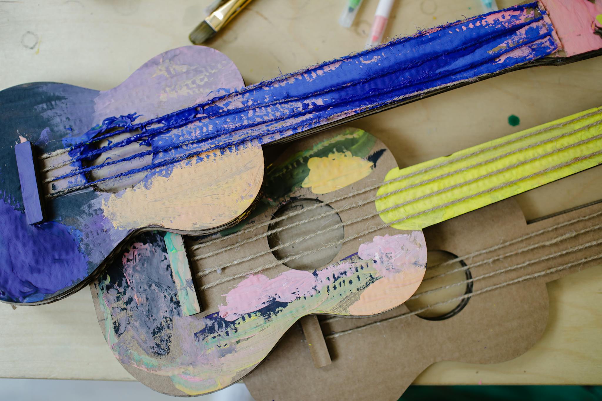 A close-up of colorful handcrafted cardboard guitars showcasing creativity and craftsmanship.